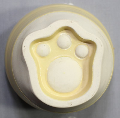 The paw on the base of a MANEKI NEKO ceramic juicer