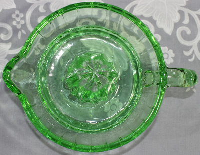 Top view of a modern green glass 1 piece twisted juicer