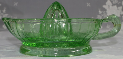 Top view of a modern green glass 1 piece twisted juicer