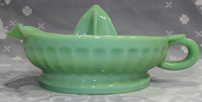 Side view of a TableCraft jadeite loop handle juicer