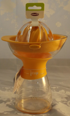 Another view of an orange and clear plastic measure Chef'n juicer