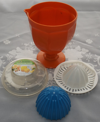 4 pieces of an orange, blue & white goblet juicer closed