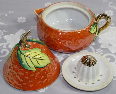 The 3 parts of a green and yellow leaves on an orange pear juicer