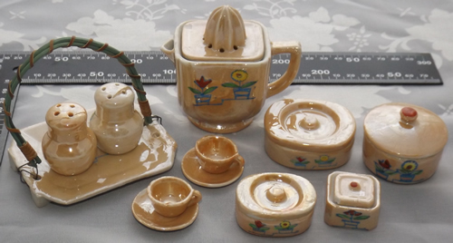 Miniature toy ceramic table set including a juicer