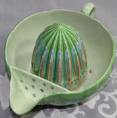 The strainer on a green Shelley drip glaze 1 piece juicer