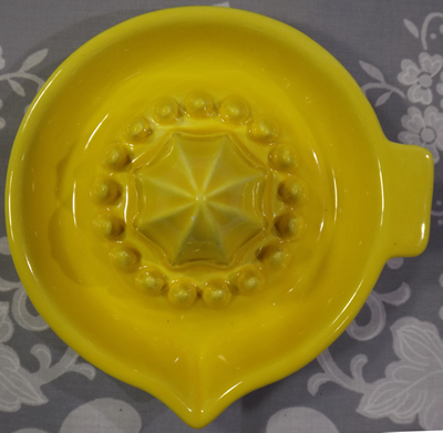 Top view of yellow ceramic saucer short pip collector juicer