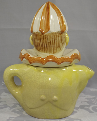 Cream clown with pale green vest juicer back view