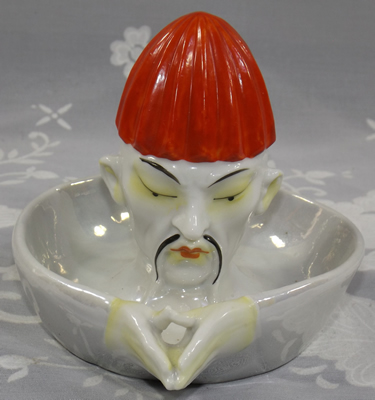 Moustached Chinese man with red hat juicer front view