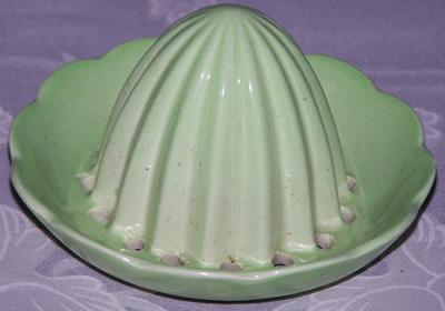 A pale green Carlton Ware juicer top