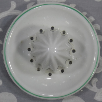 Top view of a white with green trim ceramic reamer