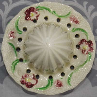 Top view of a cream with purple flowers ceramic reamer