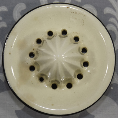 Top view of a cream with black trim ceramic reamer