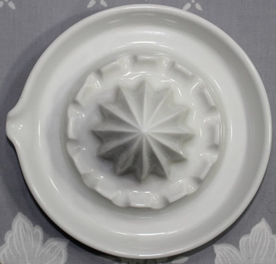 The top view of an Arzberg white ceramic saucer shape juicer