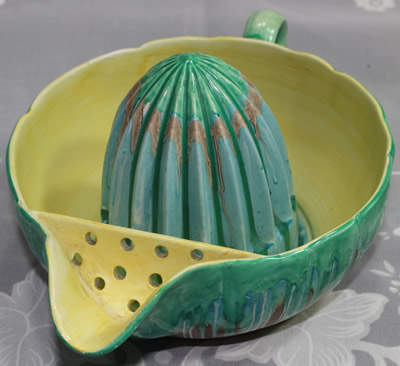 The strainer on an aqua green Shelley drip glaze 1 piece juicer