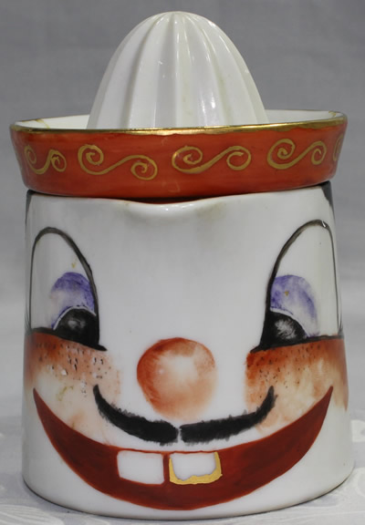 The front of a handpainted buck toothed face juicer