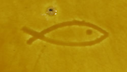 The inscribed fish mark on an orange 2 piece ceramic jug juicer with rivets