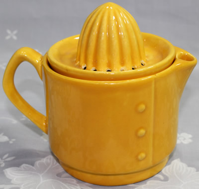 The rivets on an orange 2 piece ceramic jug juicer