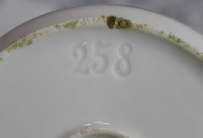 The impressewd number on a white with gold trim ceramic juicer