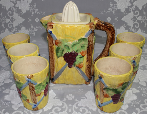 A complete yellow with grapes lemonade set ceramic juicer with matching tumblers