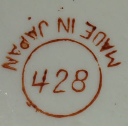 The basemark on a red on white BABY'S ORANGE juicer with lattice pattern