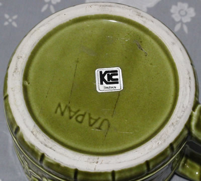 Base of a fruit on green and tumblers jug juicer