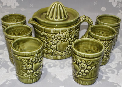 Set of fruit on green and tumblers jug juicer