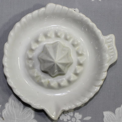 Top view of a white Japanese ceramic saucer juicer