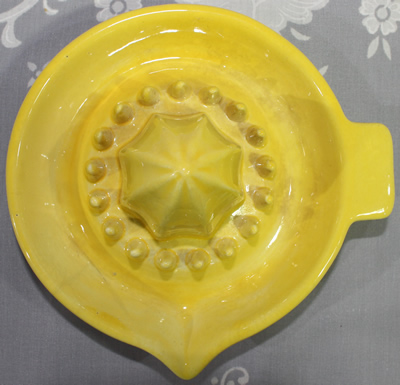 Top view ofYellow ceramic saucer tall pip collector juicer