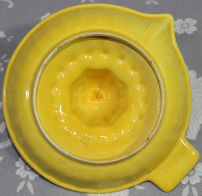 Bottom view of Yellow ceramic saucer tall pip collector juicer