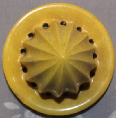 The reamer for an orange jug with a small yellow top ceramic juicer