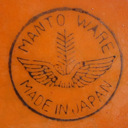 The Manto Ware basemark on an orange jug with a small yellow top juicer