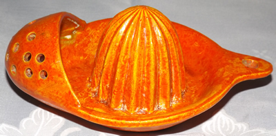 Side view of red/orange cold painter strainer juicer