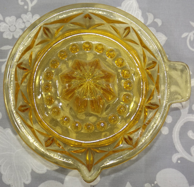 Amber glass juicer with crosses around the bowl top view