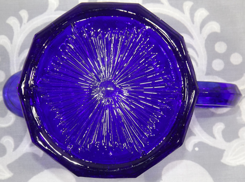 Cobalt blue glass juicer showing 'scratched circle