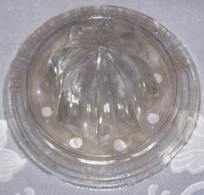 Many's Pat.Aug.25, 1885 clear glass juicer top view