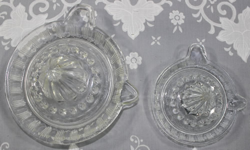 Top view of a Crown Crystal Glass salesman's model juicer compared with standard sized period juicer