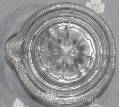 Top view of a clear glass juicer insert 