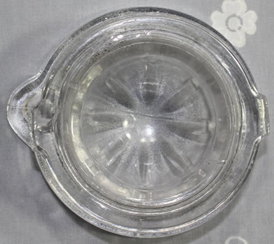 Bottom view of a clear glass juicer insert 