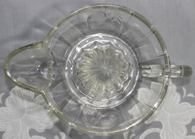 Top view of an embossed lemons on a clear glass jug like juicer