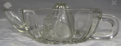 Side view of an embossed lemons on a clear glass jug like juicer