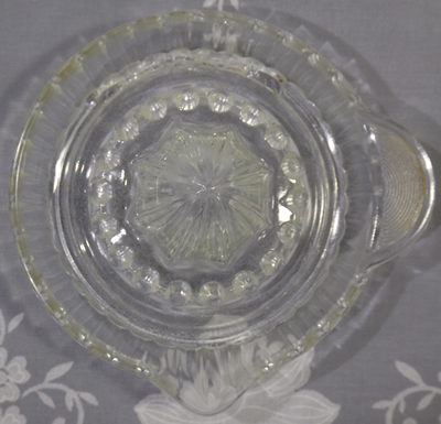 Top view of a clear glass with circles for non slip tab handle juicer