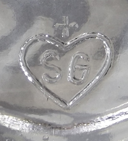 The SG in heart on tab handle of a Walther saucer shape clear glass juicer