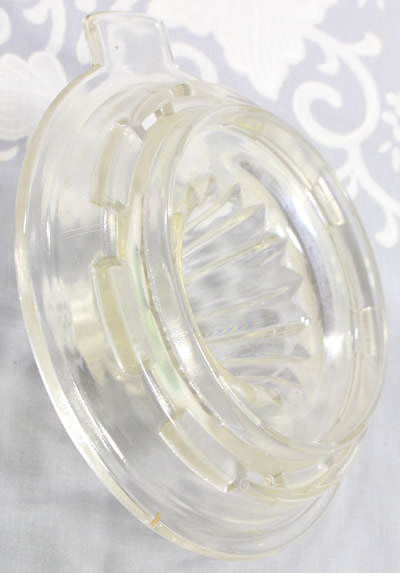 Bottom view of a Hazel Atlas Glass Co. clear glass juicer top