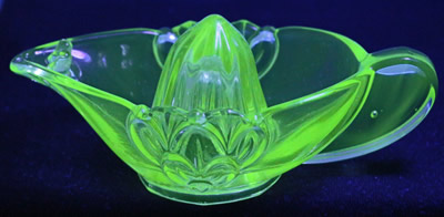 A green Stolzle of Czechoslovakia juicer under UV light