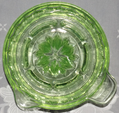 The top view of an Anchor Hocking Glass Company green glass tab handle juicer