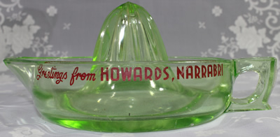 Side view of a large green Crown Crystal juicer with advertising