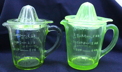 Showing the both the green glass and uranium green glass juicer jug set under UV light