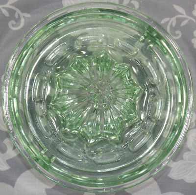 Top view of a notched pale green L E Smith juicer insert