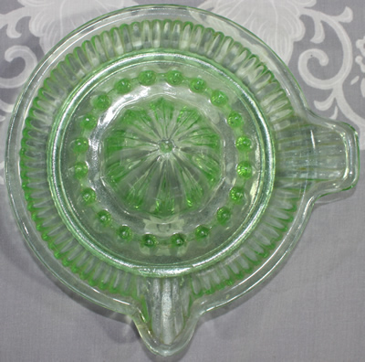 Top view of Davidson Glass saucer shape green glass juicer