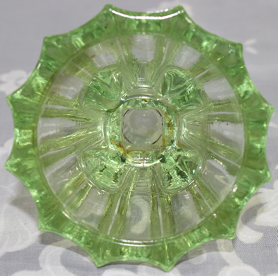 Bottom view of a green glass mechanical juicer fitting